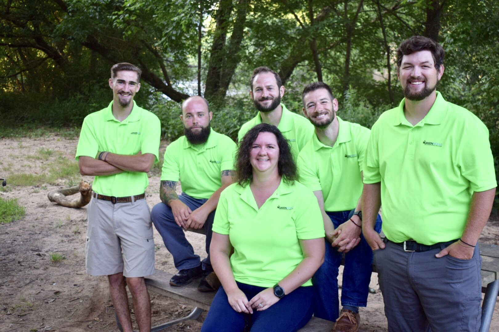 The Six Members Of The GreenWorks EcoScape Team Sitting Around A Picnic Table At The Park